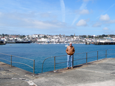 Derek on the harbour wall with the town front behind